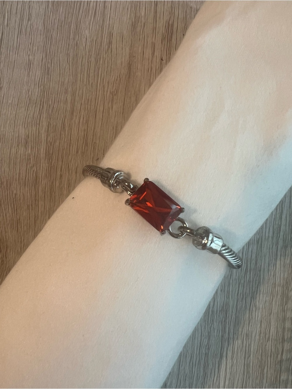 Elegant Silver-Tone Twisted Cable Bracelet with Emerald-Cut Red Gemstone